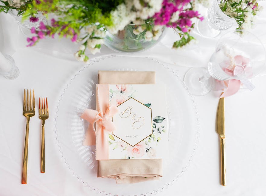 A beautifully set reception table with minimal decor, candles, and natural elements